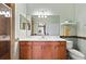 Bathroom featuring wood cabinets, a white countertop, and a walk-in shower with tile accents at 8403 Grand Estuary Trl # 301, Bradenton, FL 34212