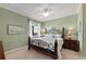 Comfortable bedroom with green walls, a ceiling fan, and an iron bed frame at 8403 Grand Estuary Trl # 301, Bradenton, FL 34212