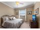 Bedroom featuring neutral walls, a ceiling fan, and window with blinds at 8403 Grand Estuary Trl # 301, Bradenton, FL 34212