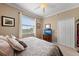 Bedroom featuring neutral walls, a ceiling fan, and a closet at 8403 Grand Estuary Trl # 301, Bradenton, FL 34212