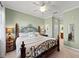 Bedroom featuring neutral walls, a ceiling fan, and an iron bed frame at 8403 Grand Estuary Trl # 301, Bradenton, FL 34212