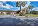 Exterior of the clubhouse with well-manicured landscaping, golf carts, and a paved entrance at 8403 Grand Estuary Trl # 301, Bradenton, FL 34212