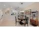 Open dining area with stylish chandelier, decorative shelving, and tile flooring adjacent to kitchen at 8403 Grand Estuary Trl # 301, Bradenton, FL 34212