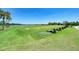 Driving range with well-maintained grass, tee areas and a lake beyond provides golfers with a scenic practice area at 8403 Grand Estuary Trl # 301, Bradenton, FL 34212