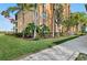 Well-maintained condo building surrounded by lush tropical landscaping with healthy green grass at 8403 Grand Estuary Trl # 301, Bradenton, FL 34212