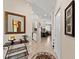 Neutral hallway showcasing elegant tile flooring, decorative mirror and tasteful decor at 8403 Grand Estuary Trl # 301, Bradenton, FL 34212