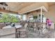 The outdoor bar features stone counter, ceiling fans and a TV for entertainment along with plenty of seating at 8403 Grand Estuary Trl # 301, Bradenton, FL 34212