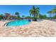 Inviting community pool with plenty of lounge chairs, surrounded by brick pavers and lush landscaping at 8403 Grand Estuary Trl # 301, Bradenton, FL 34212