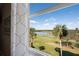 Scenic view of a lake, golf course, and palm trees from the window at 8403 Grand Estuary Trl # 301, Bradenton, FL 34212