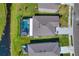 An aerial view of a home with a pool and a canal view at 8547 40Th E Cir, Palmetto, FL 34221