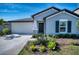 Gray house with a black door and landscaping at 8547 40Th E Cir, Palmetto, FL 34221