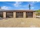 Three-car garage with brown doors and tile roof at 9 Sandy Cove Rd # 8A, Sarasota, FL 34242