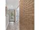 Hallway with tile floor, brick accent wall, and mirror at 9 Sandy Cove Rd # 8A, Sarasota, FL 34242