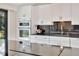 Modern kitchen with white cabinets, granite countertops and a stainless steel sink at 9 Sandy Cove Rd # 8A, Sarasota, FL 34242