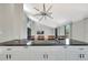 Modern kitchen island with black granite countertop and white cabinets at 9 Sandy Cove Rd # 8A, Sarasota, FL 34242