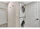 Functional laundry room with washer, dryer, and storage shelves at 9 Sandy Cove Rd # 8A, Sarasota, FL 34242