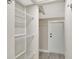 Convenient laundry room with built-in shelving and a stacked washer/dryer at 9 Sandy Cove Rd # 8A, Sarasota, FL 34242