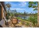 Waterfront patio with seating and lake view at 9 Sandy Cove Rd # 8A, Sarasota, FL 34242