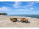 Wooden bench on rocks overlooking the calm ocean at 9 Sandy Cove Rd # 8A, Sarasota, FL 34242