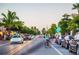 Residential street view, cyclist, parked cars, businesses visible at 9 Sandy Cove Rd # 8A, Sarasota, FL 34242