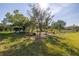 Landscaped backyard with garden and seating area at 1006 Pine Forest Ct, Venice, FL 34293