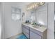 Double vanity bathroom with large mirror and window at 1006 Pine Forest Ct, Venice, FL 34293