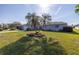 Front yard view, showing a house with palm trees at 1006 Pine Forest Ct, Venice, FL 34293