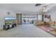 Living room offering view of the backyard through large sliding doors at 1006 Pine Forest Ct, Venice, FL 34293