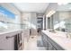 Modern bathroom featuring double vanities and a walk-in shower at 12822 Rainwashed Loop, Parrish, FL 34219