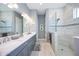 Spa-like bathroom with double sinks and a frameless shower at 12822 Rainwashed Loop, Parrish, FL 34219