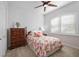 Charming bedroom with floral bedding and wood dresser at 12822 Rainwashed Loop, Parrish, FL 34219