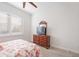 Bedroom with floral bedding, wood dresser and TV at 12822 Rainwashed Loop, Parrish, FL 34219