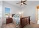 Bedroom with sleigh bed, nightstand and window at 12822 Rainwashed Loop, Parrish, FL 34219