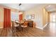 Dining area with wood table and chairs, orange curtains, and wood buffet at 12822 Rainwashed Loop, Parrish, FL 34219