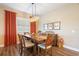 Spacious dining room with wood table and chairs, and orange accents at 12822 Rainwashed Loop, Parrish, FL 34219