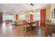 Bright dining room with a wood table and orange curtains at 12822 Rainwashed Loop, Parrish, FL 34219