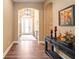 Elegant entryway with hardwood floors and decorative console table at 12822 Rainwashed Loop, Parrish, FL 34219