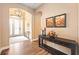 Spacious entryway with hardwood floors and console table at 12822 Rainwashed Loop, Parrish, FL 34219