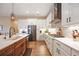 Modern kitchen with white cabinets, quartz countertops, and stainless steel appliances at 12822 Rainwashed Loop, Parrish, FL 34219