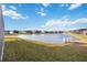 Peaceful pond view with lush grass and community homes at 12822 Rainwashed Loop, Parrish, FL 34219