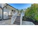 Inviting backyard shows stairs up to the home's deck and lush, tropical landscaping at 1302 Roberts Bay Ln, Sarasota, FL 34242