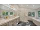 Modern bathroom featuring a double sink vanity, walk-in shower, and soaking tub at 1302 Roberts Bay Ln, Sarasota, FL 34242