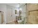 Bathroom featuring tiled glass shower, gray vanity and a white door at 1302 Roberts Bay Ln, Sarasota, FL 34242