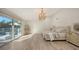 Light-filled bedroom with access to a balcony, modern chandelier, and luxury finishes at 1302 Roberts Bay Ln, Sarasota, FL 34242