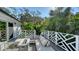 Stunning outdoor deck features stylish seating around a modern fire pit and lush tropical landscaping at 1302 Roberts Bay Ln, Sarasota, FL 34242