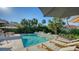 Inviting pool and lounge chairs are surrounded by tropical trees and foliage at 1302 Roberts Bay Ln, Sarasota, FL 34242