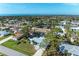 Coastal community aerial view featuring beautiful homes with green surroundings and partial ocean view at 1346 Queen Rd, Venice, FL 34293