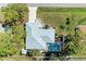 Aerial view of a home featuring a screen enclosed pool and well-manicured yard at 1346 Queen Rd, Venice, FL 34293