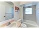 Bathroom featuring an integrated tub and shower, a toilet, and a vanity with a decorative mirror at 1346 Queen Rd, Venice, FL 34293