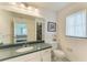 Bright bathroom featuring a vanity with a sleek countertop and a view into the bedroom and the shower at 1346 Queen Rd, Venice, FL 34293